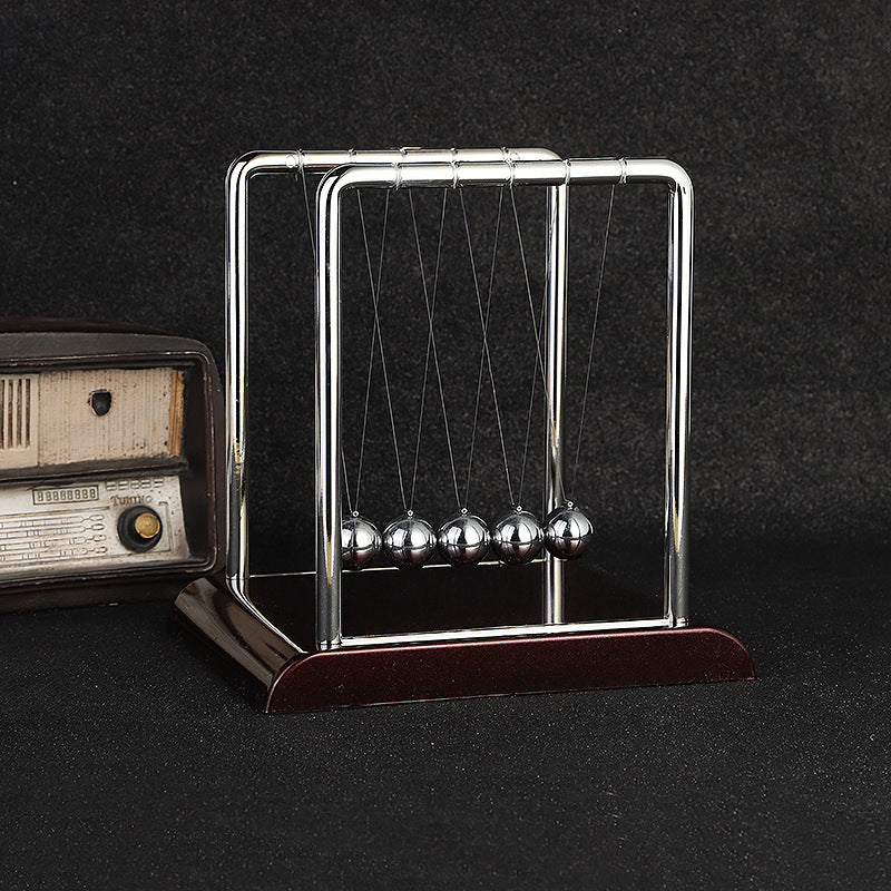 Side view showing motion of Newton's Cradle desk toy