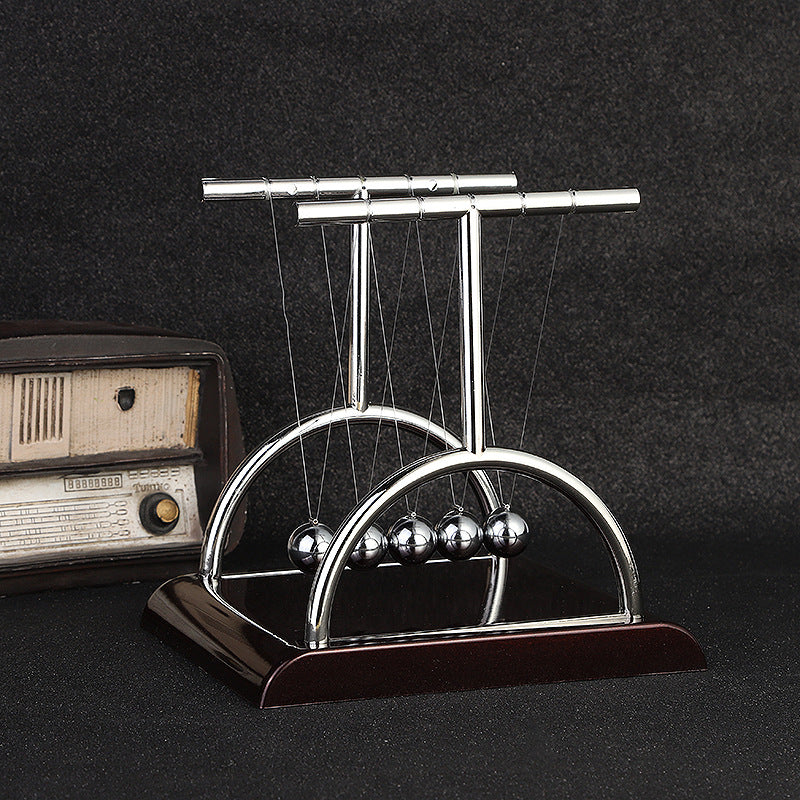 Kinetic desk toy capturing Newton's third law of motion