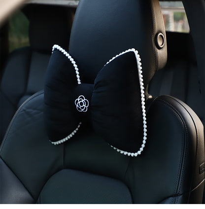 plush black headrest with white camellia pattern