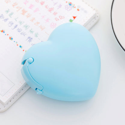 cartoon heart and donut tape dispenser on desk