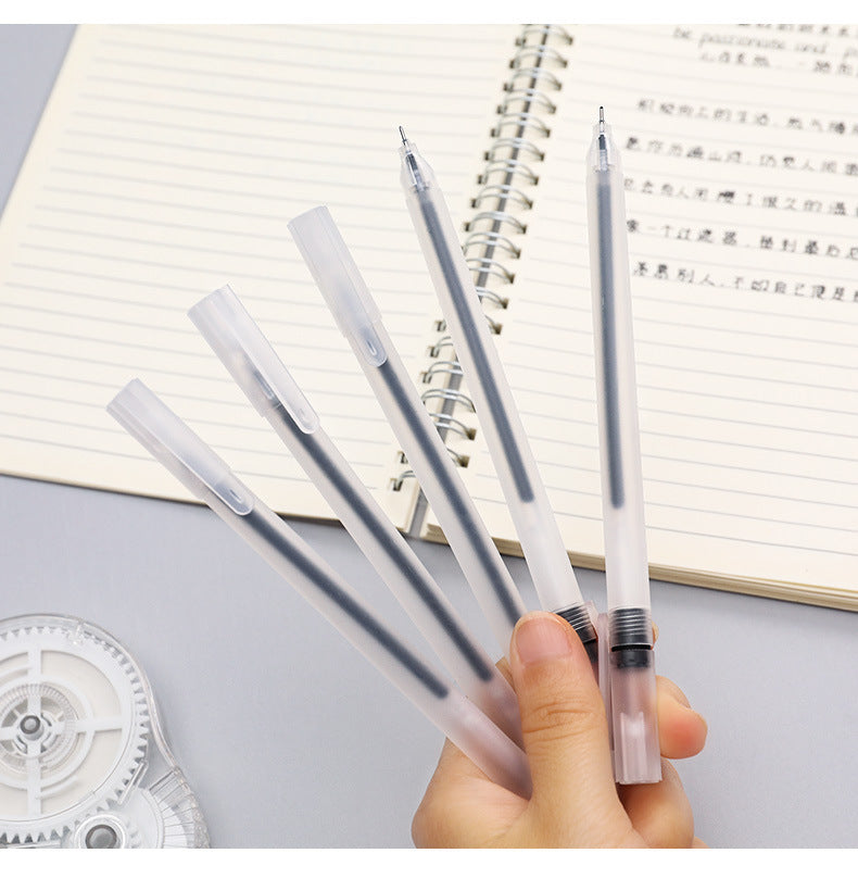 person writing notes with black gel pen