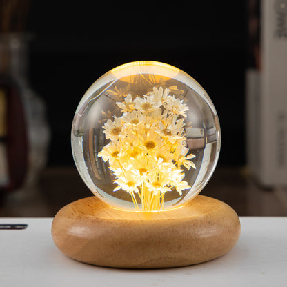 elegant crystal ball with internal dandelion figure and wooden base