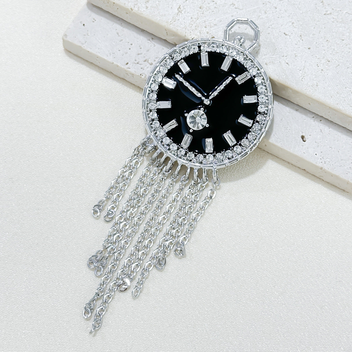 Close-up of stylish brooch with tassels
