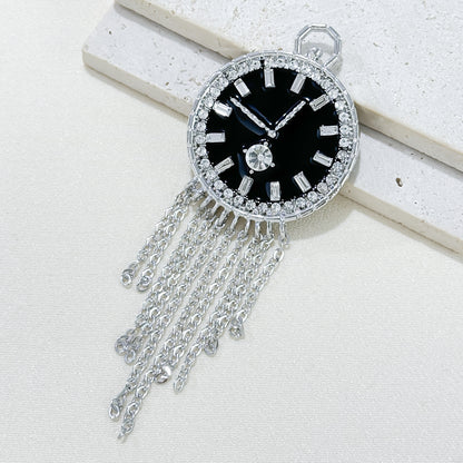 Close-up of stylish brooch with tassels