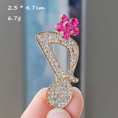 Heart-shaped musical note brooch design