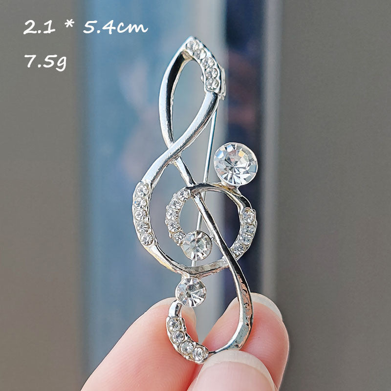 Heart-shaped musical note brooch design