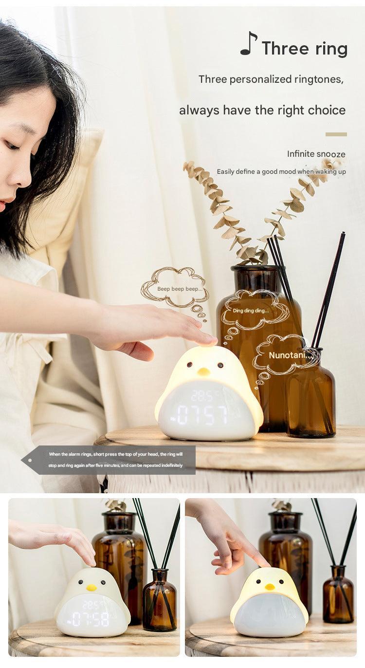 white bird-shaped alarm clock with LED on nightstand