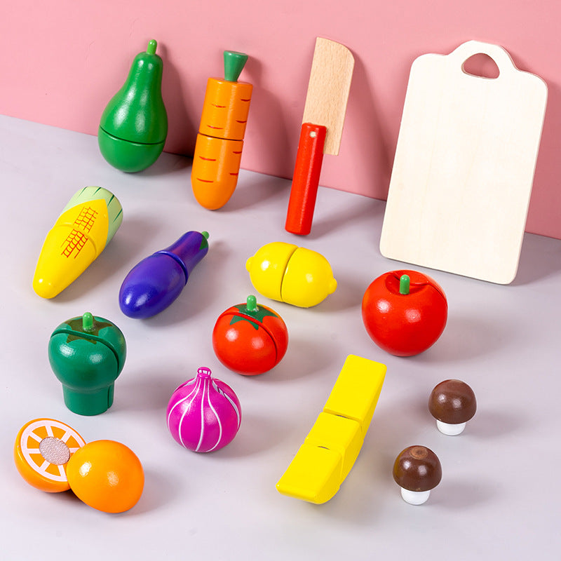 child playing with wooden vegetable cutting toy