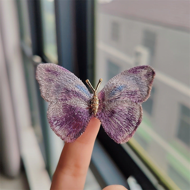 Fashionable butterfly brooch on scarf