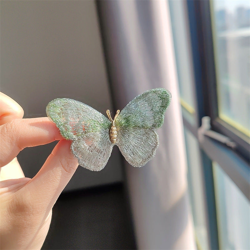 Fashionable butterfly brooch on scarf