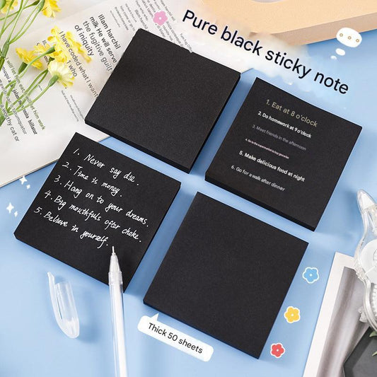 black sticky note pad on desk