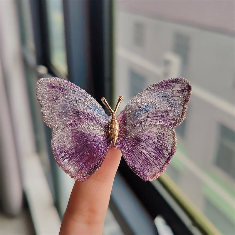 Butterfly embroidered brooch in purple